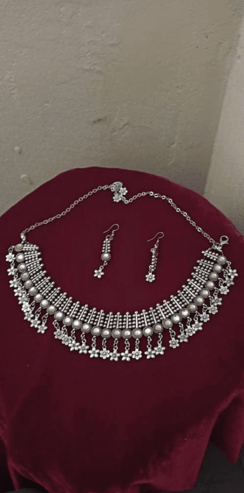 A silver necklace and earrings made in class